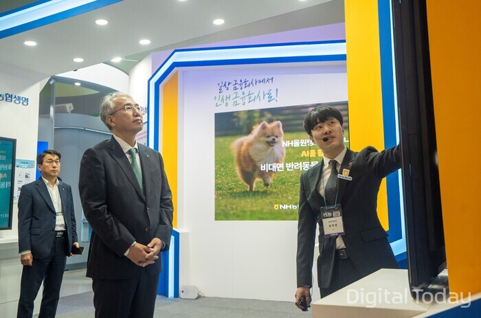 NH농협금융은 8월27일부터 8월29일까지 3일 간 동대문디자인플라자(DDP)에서2024 NHAX 체험관을 운영한다. 이석준 NH농협금융그룹 회장(가운데)이 NHAX 체험관에서 NH투자증권의‘차트분석AI’서비스를 보고 있다. [사진: NH농협금융]