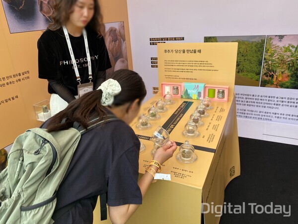쿠지리스 부스에서 녹후추를 시향하는 고객. [사진: 디지털투데이 손슬기 기자]